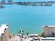 Scenic aerial view of the coastal condos, nearby harbor, and clear ocean at 4700 Cove Cir # 301, St Petersburg, FL 33708