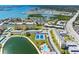 Beautiful waterfront community featuring multiple buildings, a pool, tennis courts, and a scenic pond at 4700 Cove Cir # 301, St Petersburg, FL 33708