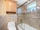 Bathroom with a shower-tub combo and wooden storage cabinet at 4700 Cove Cir # 301, St Petersburg, FL 33708