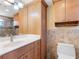 Bathroom vanity, storage cabinet, toilet, and a glass-enclosed shower at 4700 Cove Cir # 301, St Petersburg, FL 33708
