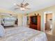 Bedroom with carpet, ceiling fan, closet and en suite bathroom at 4700 Cove Cir # 301, St Petersburg, FL 33708