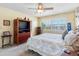 Cozy bedroom features a ceiling fan, carpet, and a window with shutters at 4700 Cove Cir # 301, St Petersburg, FL 33708