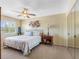 Bedroom with carpet, ceiling fan, mirrored closet and a side table at 4700 Cove Cir # 301, St Petersburg, FL 33708