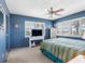 Blue bedroom featuring a ceiling fan and multiple windows at 4700 Cove Cir # 301, St Petersburg, FL 33708