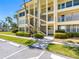 Inviting building entrance with manicured bushes, stairs, and a well-maintained walkway at 4700 Cove Cir # 301, St Petersburg, FL 33708