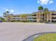 Exterior view of a well-maintained three-story building with lots of parking and palm tree landscaping at 4700 Cove Cir # 301, St Petersburg, FL 33708