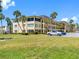 Well-maintained three-story building featuring covered balconies, well-manicured landscaping, and plenty of parking at 4700 Cove Cir # 301, St Petersburg, FL 33708