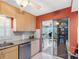 Kitchen with granite countertops, light wood cabinetry, and stainless steel appliances at 4700 Cove Cir # 301, St Petersburg, FL 33708