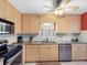 Kitchen showcasing stainless steel appliances, light wood cabinetry and granite countertops at 4700 Cove Cir # 301, St Petersburg, FL 33708