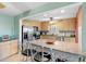 Kitchen with stainless steel appliances, breakfast bar and light wood cabinets at 4700 Cove Cir # 301, St Petersburg, FL 33708