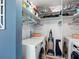 Convenient laundry room featuring a washer, dryer, and plenty of storage space on the shelves above at 4700 Cove Cir # 301, St Petersburg, FL 33708