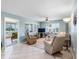Comfortable living room with natural light, tile flooring, a ceiling fan, and a view into the sunroom at 4700 Cove Cir # 301, St Petersburg, FL 33708