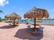 Picnic area with tiki-style umbrellas overlooking the water at 4700 Cove Cir # 301, St Petersburg, FL 33708