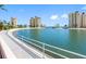 Scenic pond with a white railing and views of nearby condo buildings at 4700 Cove Cir # 301, St Petersburg, FL 33708