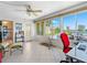 Bright sunroom with tile floors and large windows, offering stunning outdoor views and access to the kitchen at 4700 Cove Cir # 301, St Petersburg, FL 33708