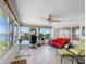 Bright sunroom with large windows, tiled floors, ceiling fan, and a comfortable seating area, perfect for relaxation at 4700 Cove Cir # 301, St Petersburg, FL 33708
