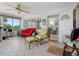 Cozy sunroom with tiled flooring, a ceiling fan, comfortable seating, and views into another room at 4700 Cove Cir # 301, St Petersburg, FL 33708