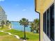 Relaxing water view with palm trees and a walking path, perfect for enjoying the scenery at 4700 Cove Cir # 301, St Petersburg, FL 33708