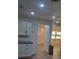 Bright hallway featuring pristine white walls, recessed lighting, and modern wood-look flooring at 4824 Huntington Ne St, St Petersburg, FL 33703
