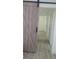 Hallway with wood-look floors and a sliding barn door leads to additional rooms in the house at 4824 Huntington Ne St, St Petersburg, FL 33703
