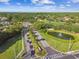 An aerial view showcases the lush landscaping, a tranquil pond, a golf course, and well-planned streets at 5027 Cross Pointe Dr, Oldsmar, FL 34677