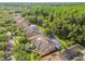 An aerial view of homes in a neighborhood with lush landscaping, mature trees, and access to a nature preserve at 5027 Cross Pointe Dr, Oldsmar, FL 34677
