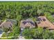 An aerial view of homes featuring solar panels on the roofs and views of a beautiful wooded lot at 5027 Cross Pointe Dr, Oldsmar, FL 34677