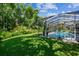 Lush backyard with a screened-in pool offering a private, tranquil oasis at 5027 Cross Pointe Dr, Oldsmar, FL 34677