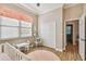 Bright, charming Bedroom with wood floors, mini table set, and crib, perfect for a new Gathering at 5027 Cross Pointe Dr, Oldsmar, FL 34677