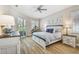 Comfortable bedroom with a ceiling fan, shuttered windows, and a sliding glass door at 5027 Cross Pointe Dr, Oldsmar, FL 34677