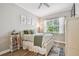 Cozy bedroom with a decorative bed, window, rug, and white furnishings at 5027 Cross Pointe Dr, Oldsmar, FL 34677