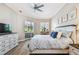 Comfortable bedroom with a fan, dresser, and a sliding door to the outside screened in area at 5027 Cross Pointe Dr, Oldsmar, FL 34677