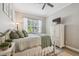 Bright bedroom featuring a decorative bed, window, rug, and a white dresser at 5027 Cross Pointe Dr, Oldsmar, FL 34677