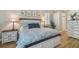 Comfortable bedroom with a queen-size bed, wood flooring, and shuttered windows at 5027 Cross Pointe Dr, Oldsmar, FL 34677