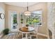 Bright breakfast nook with a fireplace, a round table, and a view of the screened-in pool at 5027 Cross Pointe Dr, Oldsmar, FL 34677