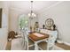 Formal dining room boasting an arched window, elegant lighting, and a white buffet at 5027 Cross Pointe Dr, Oldsmar, FL 34677