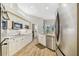 Well-lit kitchen featuring stainless steel appliances, granite countertops, and white cabinets at 5027 Cross Pointe Dr, Oldsmar, FL 34677
