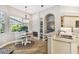 Kitchen featuring stainless sink, stone backsplash, and a view into the breakfast nook and fireplace at 5027 Cross Pointe Dr, Oldsmar, FL 34677