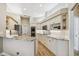 Bright kitchen featuring white cabinets, granite countertops, stainless appliances, and wood flooring at 5027 Cross Pointe Dr, Oldsmar, FL 34677