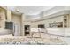 Spacious kitchen with granite countertops, stainless appliances, white cabinets, and wood flooring at 5027 Cross Pointe Dr, Oldsmar, FL 34677