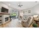 Comfortable living room featuring a fireplace, a ceiling fan, and sliding glass doors to the pool area at 5027 Cross Pointe Dr, Oldsmar, FL 34677