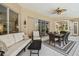 Covered patio features a dining area, ceiling fan, and comfortable seating for outdoor entertaining at 5027 Cross Pointe Dr, Oldsmar, FL 34677
