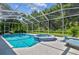 Inviting pool and spa area with screened enclosure, ideal for outdoor relaxation and entertainment at 5027 Cross Pointe Dr, Oldsmar, FL 34677