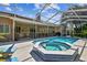 Beautiful pool and hot tub with lanai, surrounded by lush landscaping, perfect for relaxing outdoors at 5027 Cross Pointe Dr, Oldsmar, FL 34677