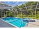 Sparkling pool and spa surrounded by a screened-in enclosure and lush landscaping at 5027 Cross Pointe Dr, Oldsmar, FL 34677