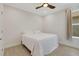 Cozy bedroom features a ceiling fan, natural light, and neutral walls at 5410 Morey Farms Loop, Palmetto, FL 34221