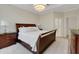 This primary bedroom features a wooden bed frame, a modern chandelier, and lots of natural light at 5410 Morey Farms Loop, Palmetto, FL 34221