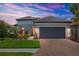 Charming one-story home with a paver driveway, lush landscaping, and a two car garage at 5410 Morey Farms Loop, Palmetto, FL 34221