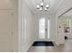 Bright foyer features decorative trim, and a front door with glass detail that welcomes guests at 5410 Morey Farms Loop, Palmetto, FL 34221