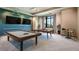 Well-appointed game room featuring a pool table, ping pong table, and comfortable seating at 5410 Morey Farms Loop, Palmetto, FL 34221
